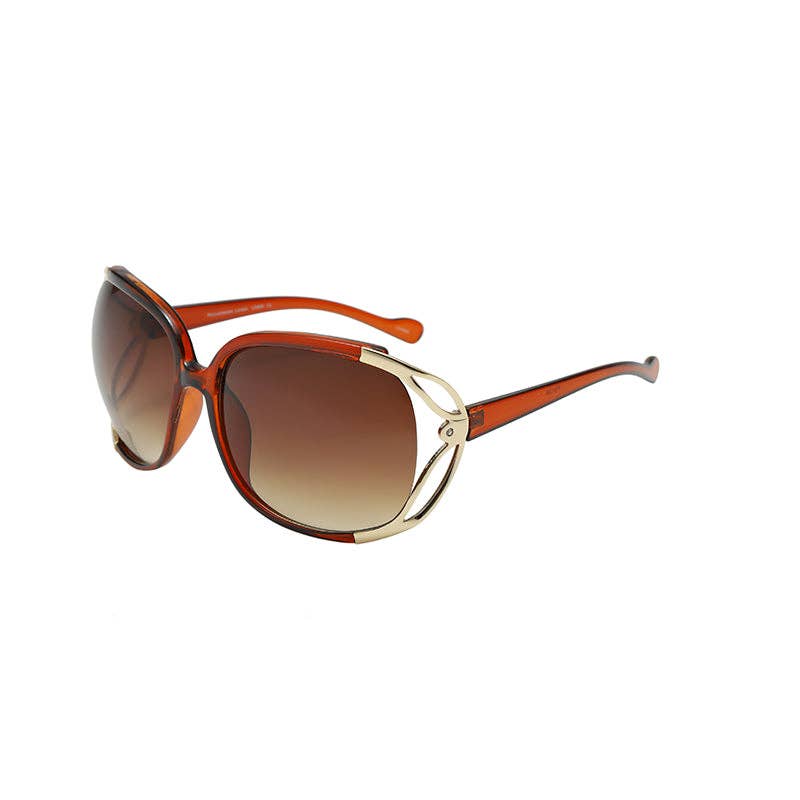 Sunglasses with brown gradient lenses and gold frame on a white background