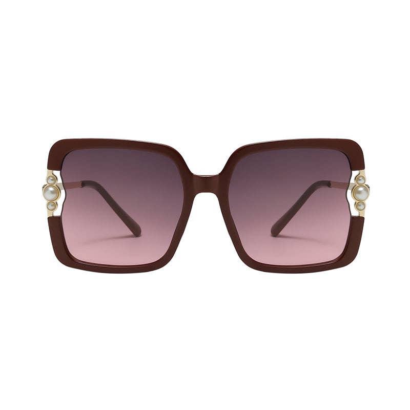 Sunglasses with brown frame and pink gradient lenses on a white background