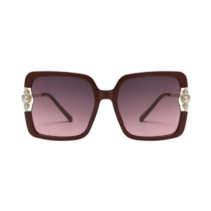 Sunglasses with brown frame and pink gradient lenses on a white background